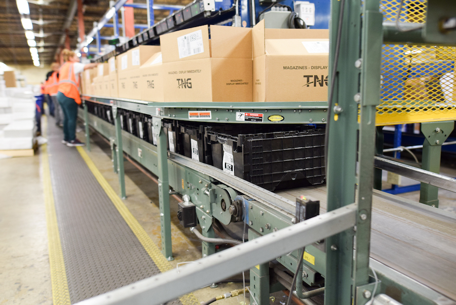 People packing boxes on assembly line